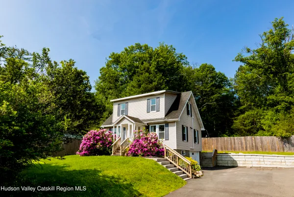 a front view of a house with a garden