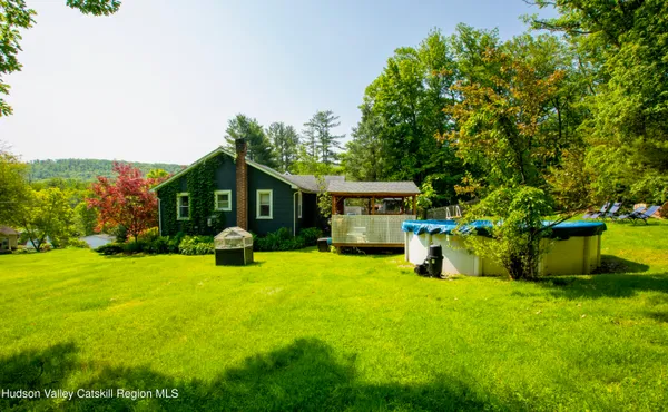 a front view of a house with yard and green space