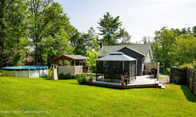 a view of a house with swimming pool and sitting area