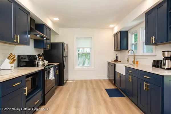 a kitchen with a sink a refrigerator and cabinets