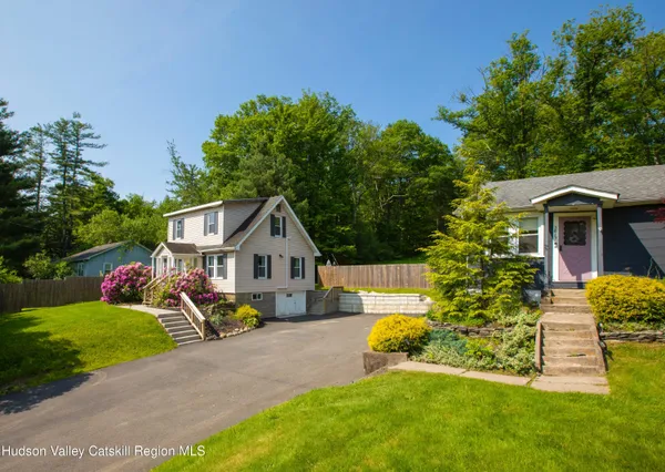 a view of a house with a yard and sitting area
