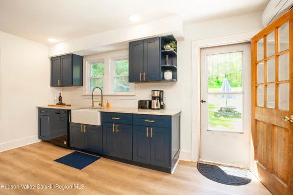 a spacious bathroom with a double vanity sink a mirror and a bathtub