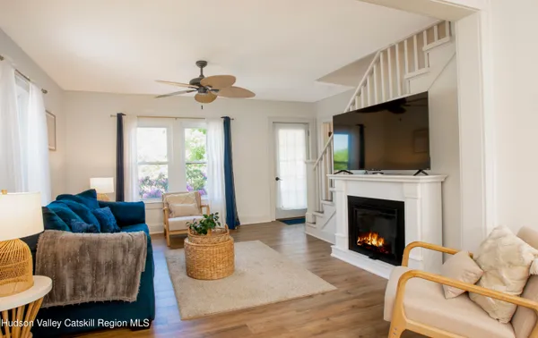 a living room with furniture a flat screen tv and a fireplace