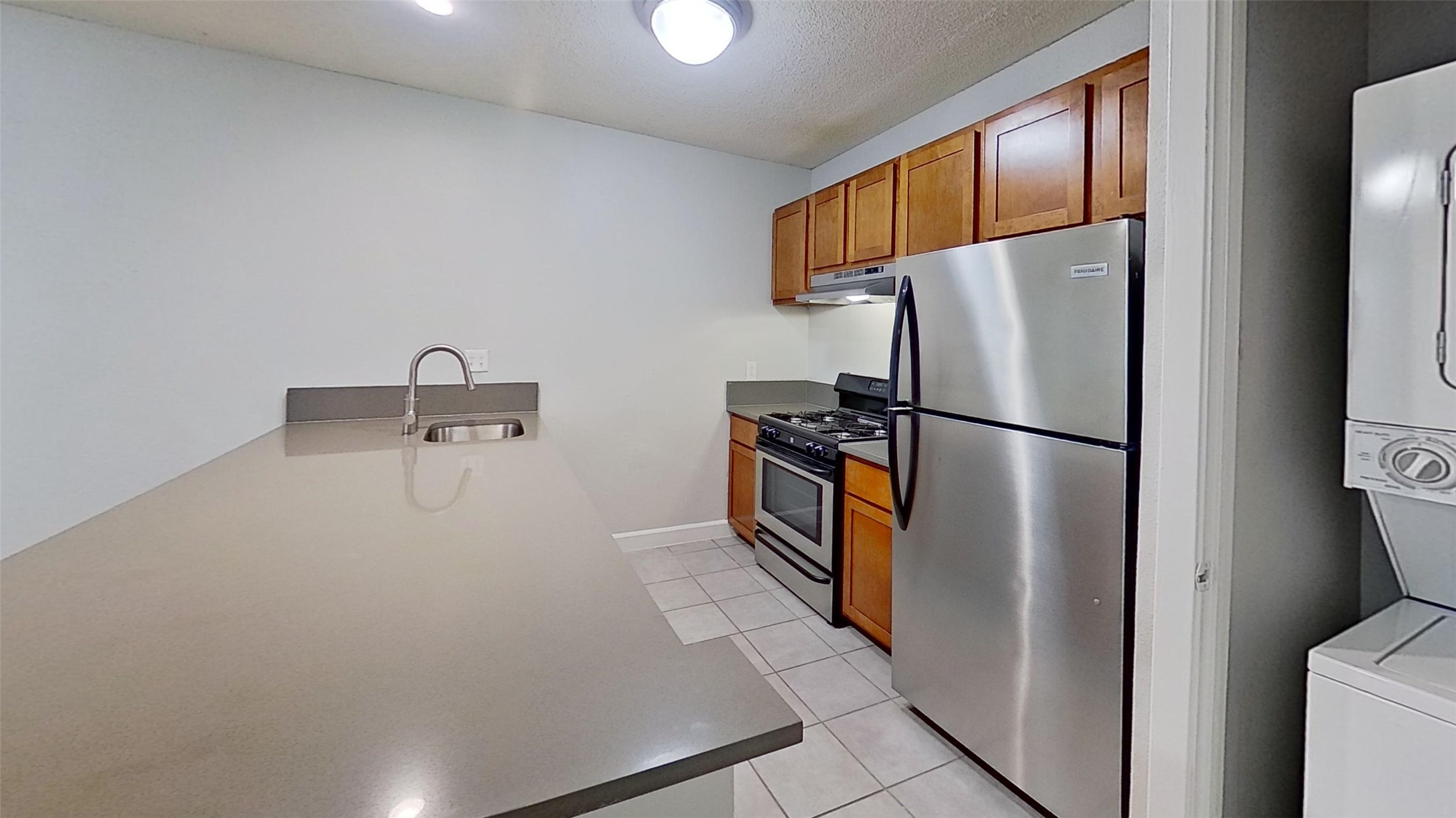 2520 Longview Street, Unit 405 Austin, TX 78705 - Photo 2 of 9 a kitchen with stainless steel appliances a refrigerator and a sink