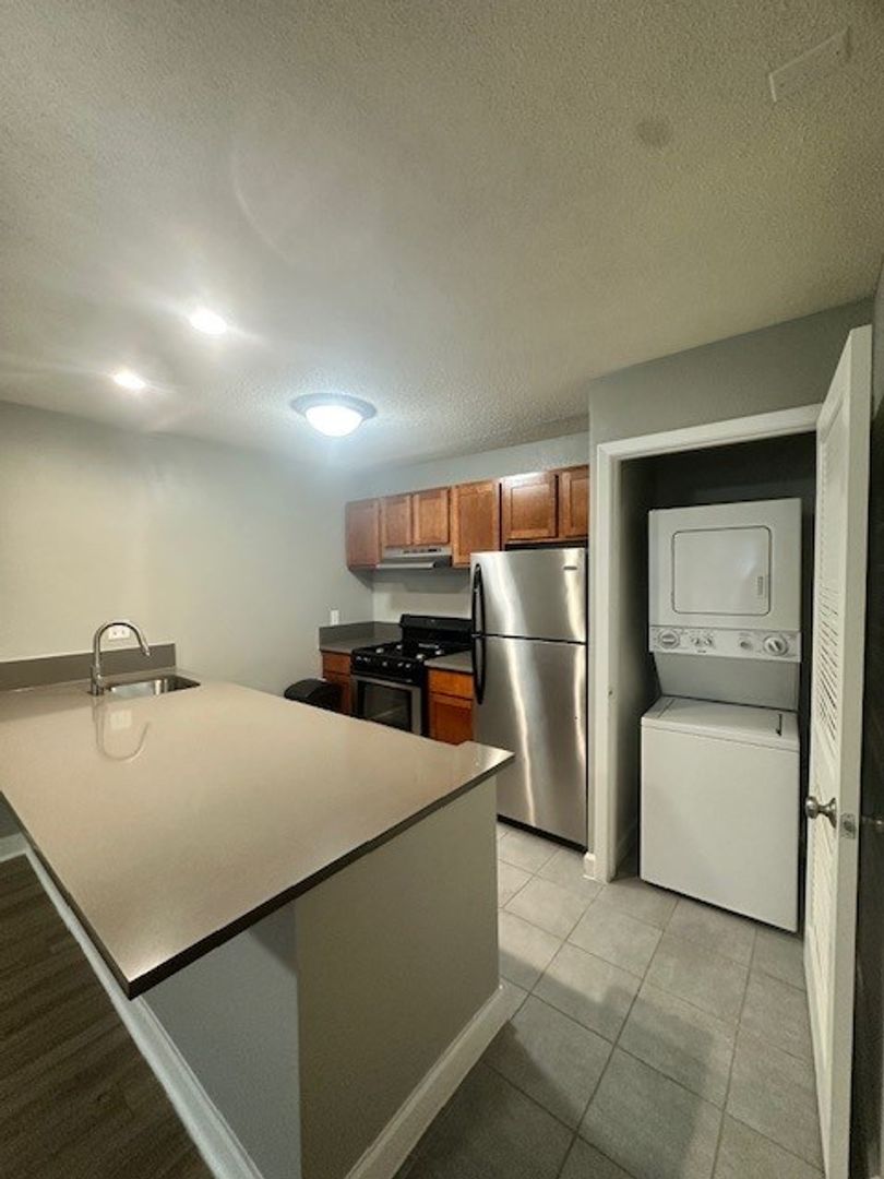 2520 Longview Street, Unit 405 Austin, TX 78705 - Photo 2 of 11 a kitchen with stainless steel appliances a refrigerator sink and stove