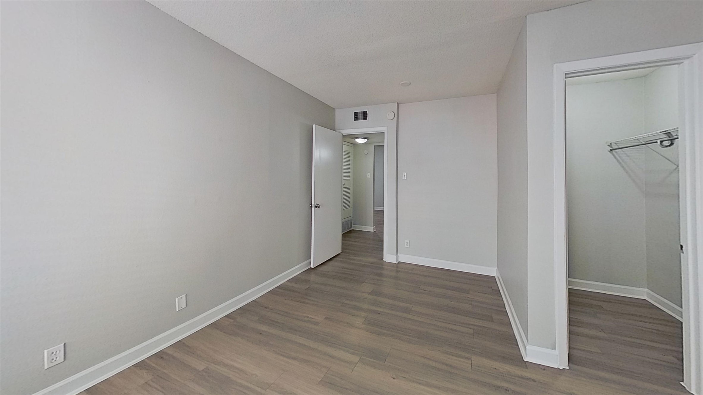 2520 Longview Street, Unit 405 Austin, TX 78705 - Photo 4 of 9 a view of an empty room with wooden floor