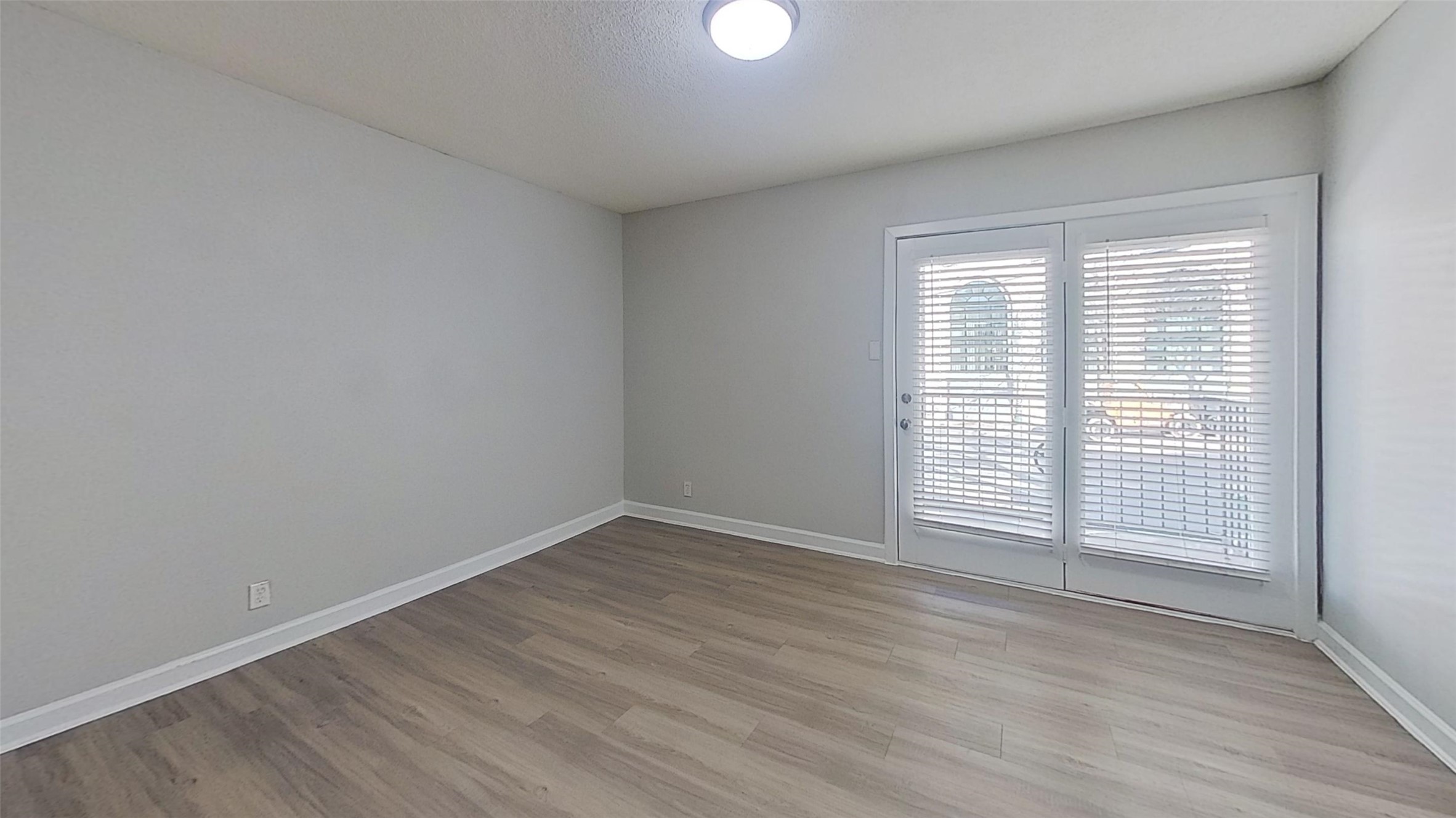 2520 Longview Street, Unit 405 Austin, TX 78705 - Photo 5 of 9 an empty room with wooden floor and windows