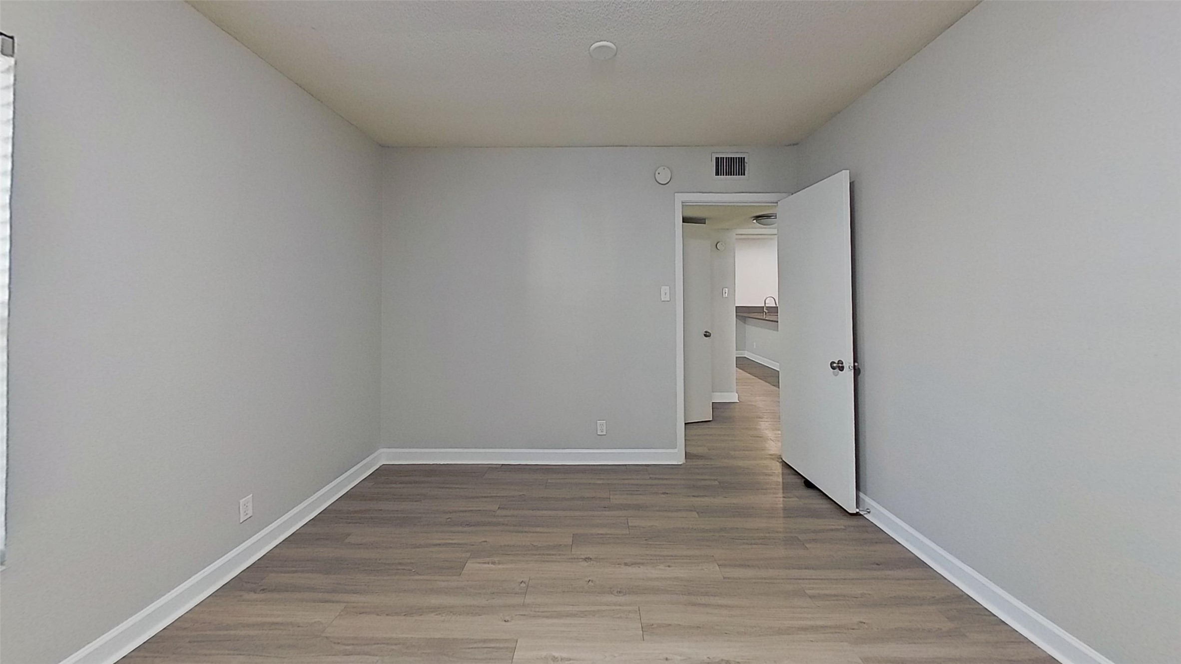 2520 Longview Street, Unit 405 Austin, TX 78705 - Photo 6 of 9 a view of an empty room and wooden floor