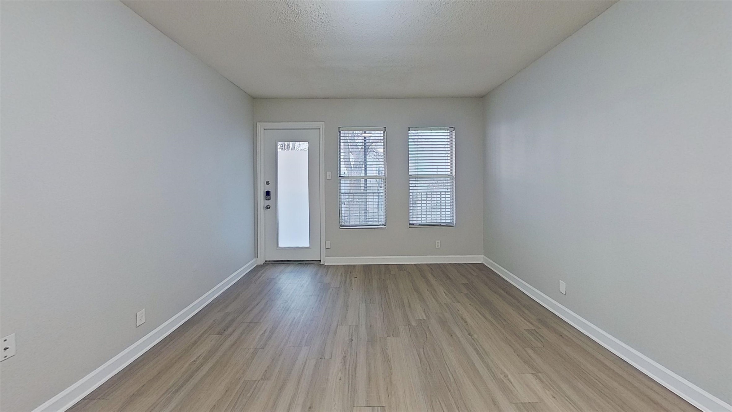 2520 Longview Street, Unit 405 Austin, TX 78705 - Photo 7 of 9 wooden floor in an empty room with a window