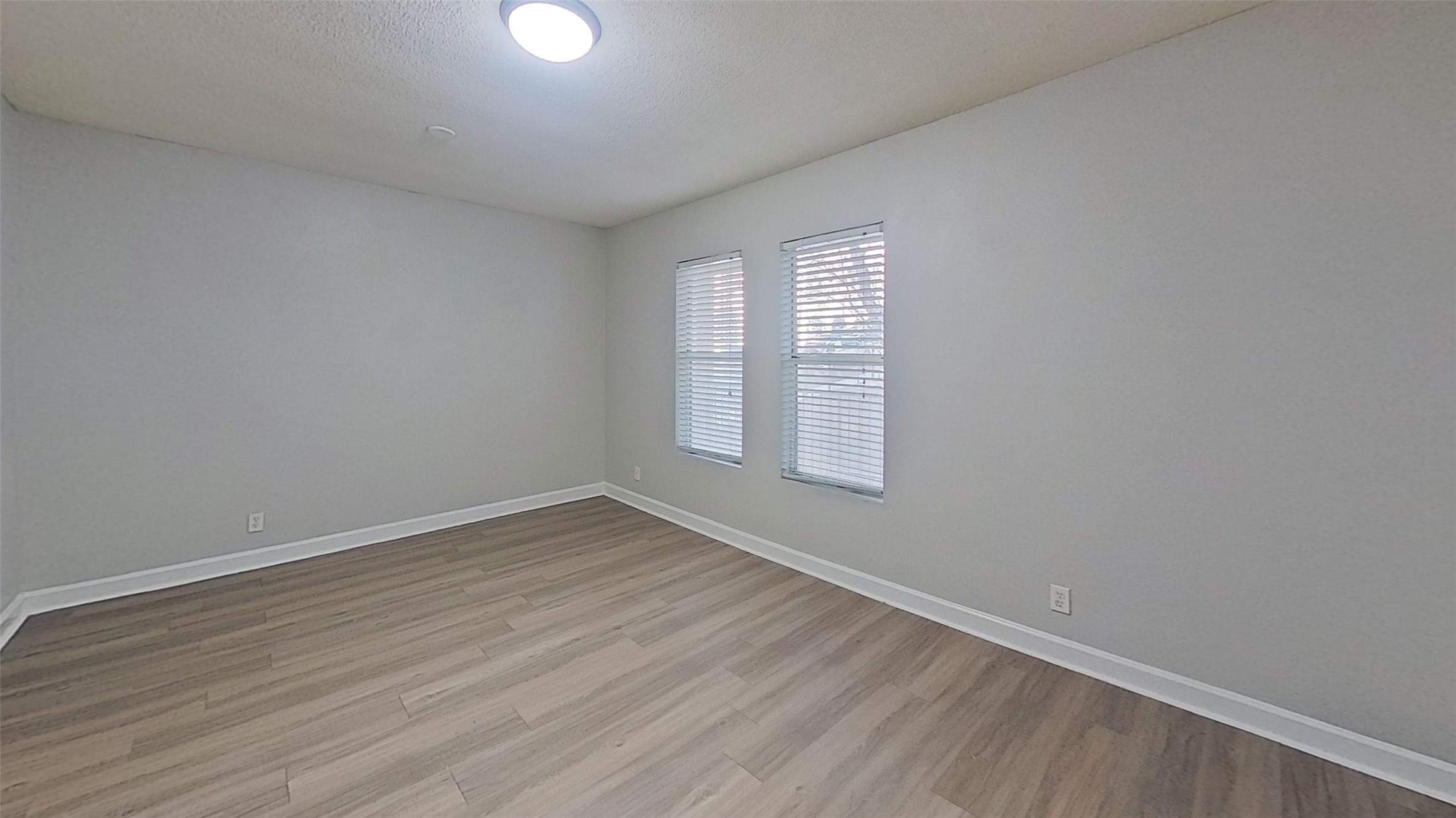 2520 Longview Street, Unit 405 Austin, TX 78705 - Photo 8 of 9 wooden floor in an empty room with a window