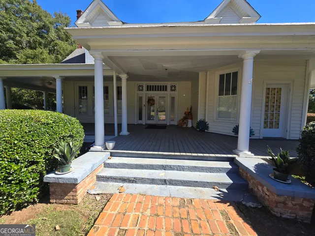 a view of a house with couches chair and floor to ceiling window
