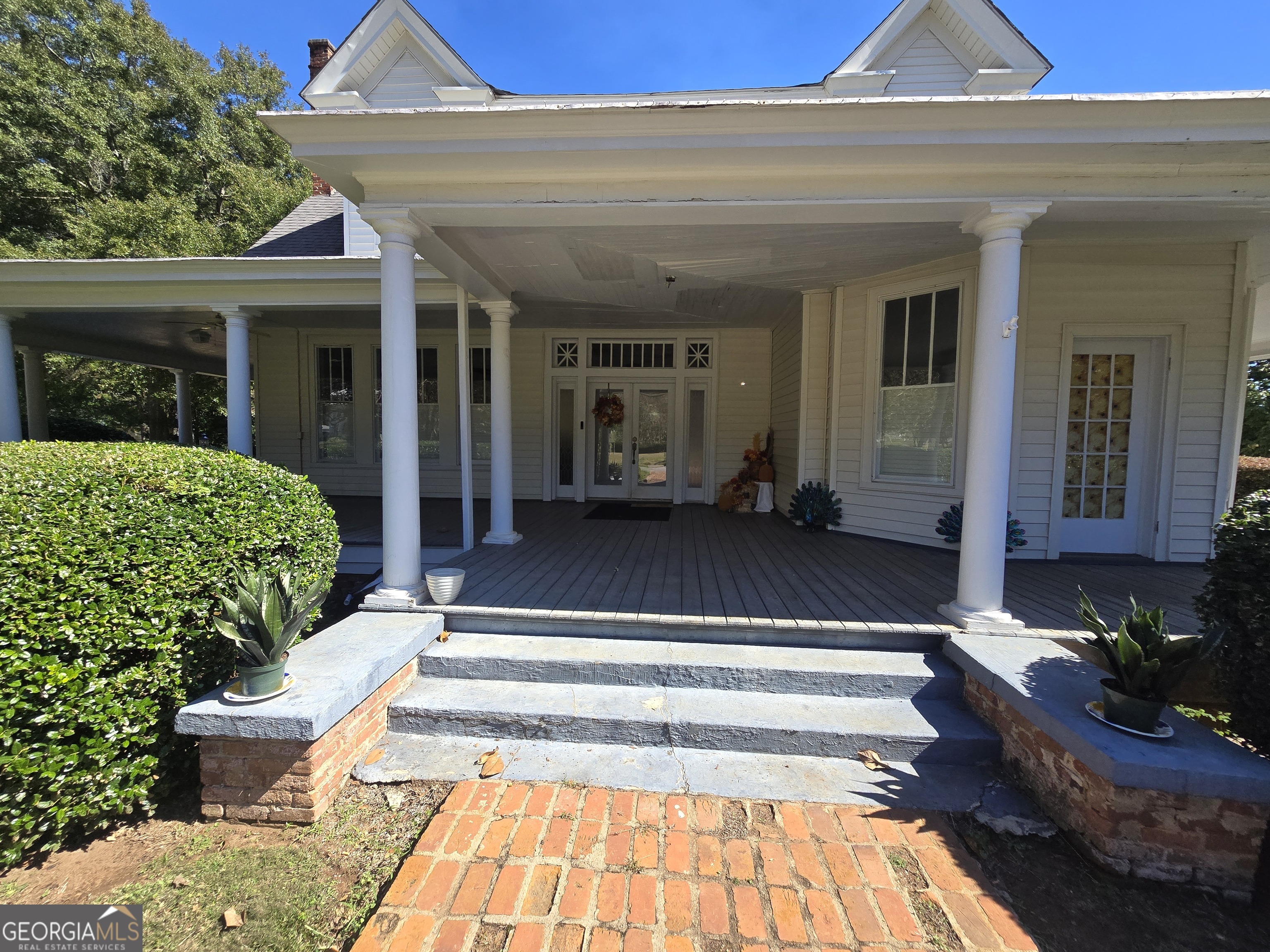a view of a house with couches chair and floor to ceiling window