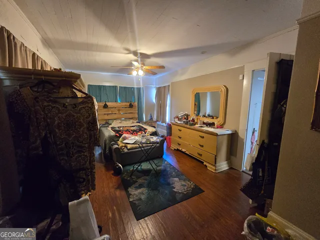 a bedroom with furniture and a mirror