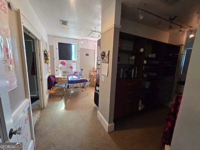 a hallway with living room and furniture