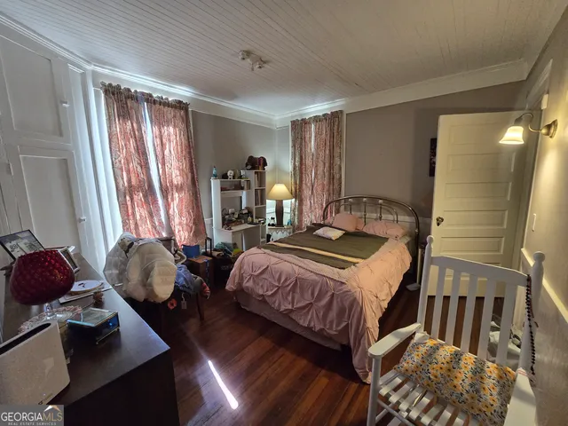 a bedroom with bed and a window