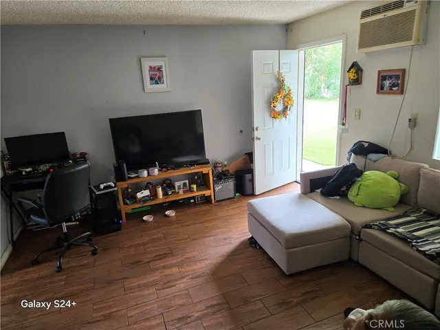 a bedroom with furniture and a flat screen tv