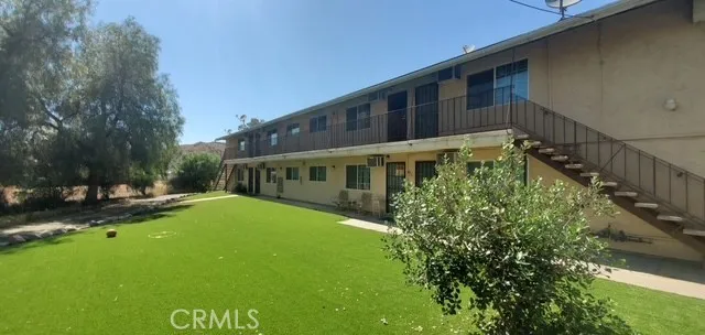 a view of house with yard and green space