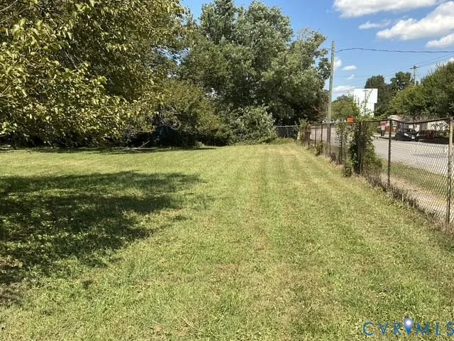 a view of yard with swimming pool and seating