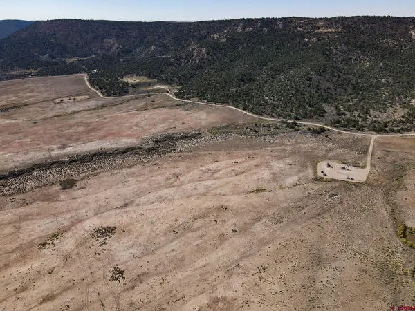 a view of dirt field with mountain view