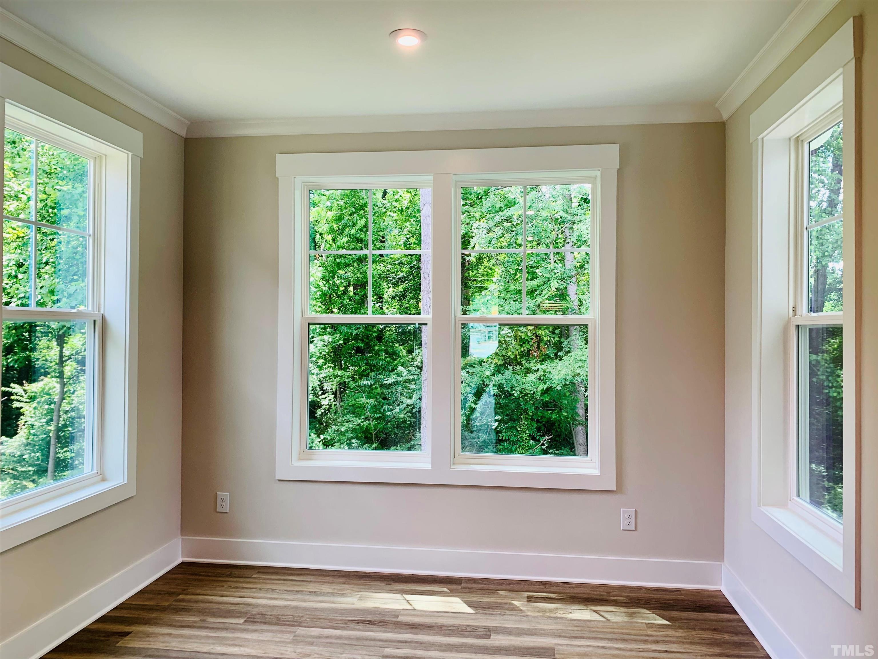 163 DUNLOE Loop Raleigh, NC 27603 - Photo 12 of 32 a view of an empty room with wooden floor and a window