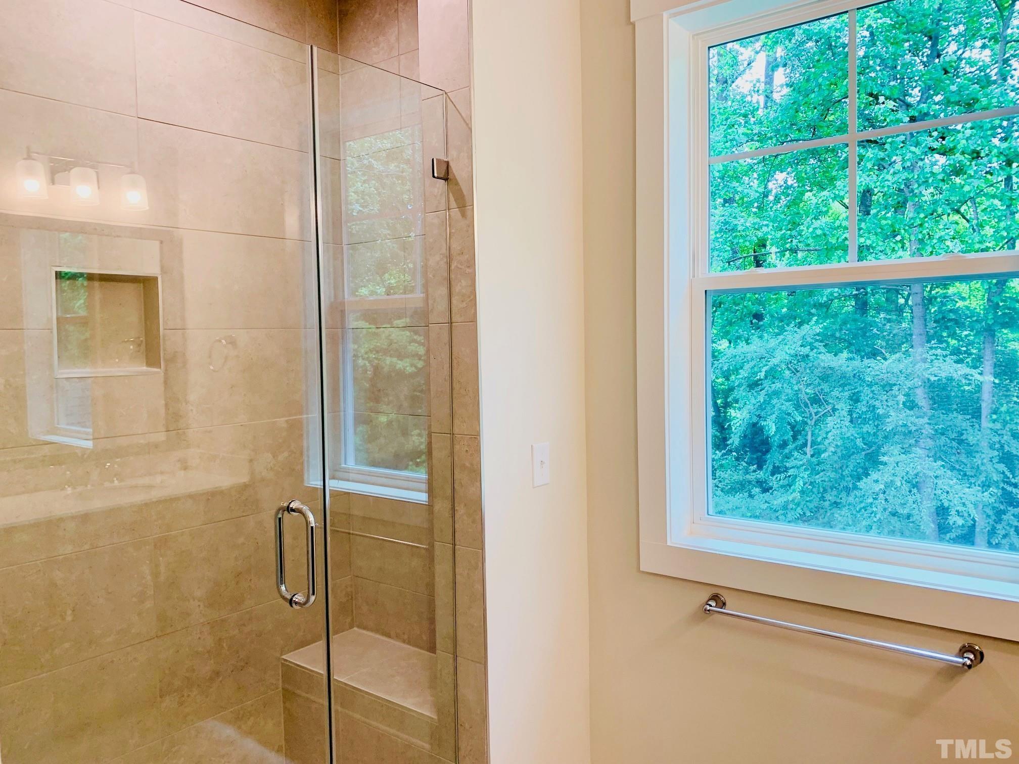 163 DUNLOE Loop Raleigh, NC 27603 - Photo 14 of 32 a bathroom with a glass shower door