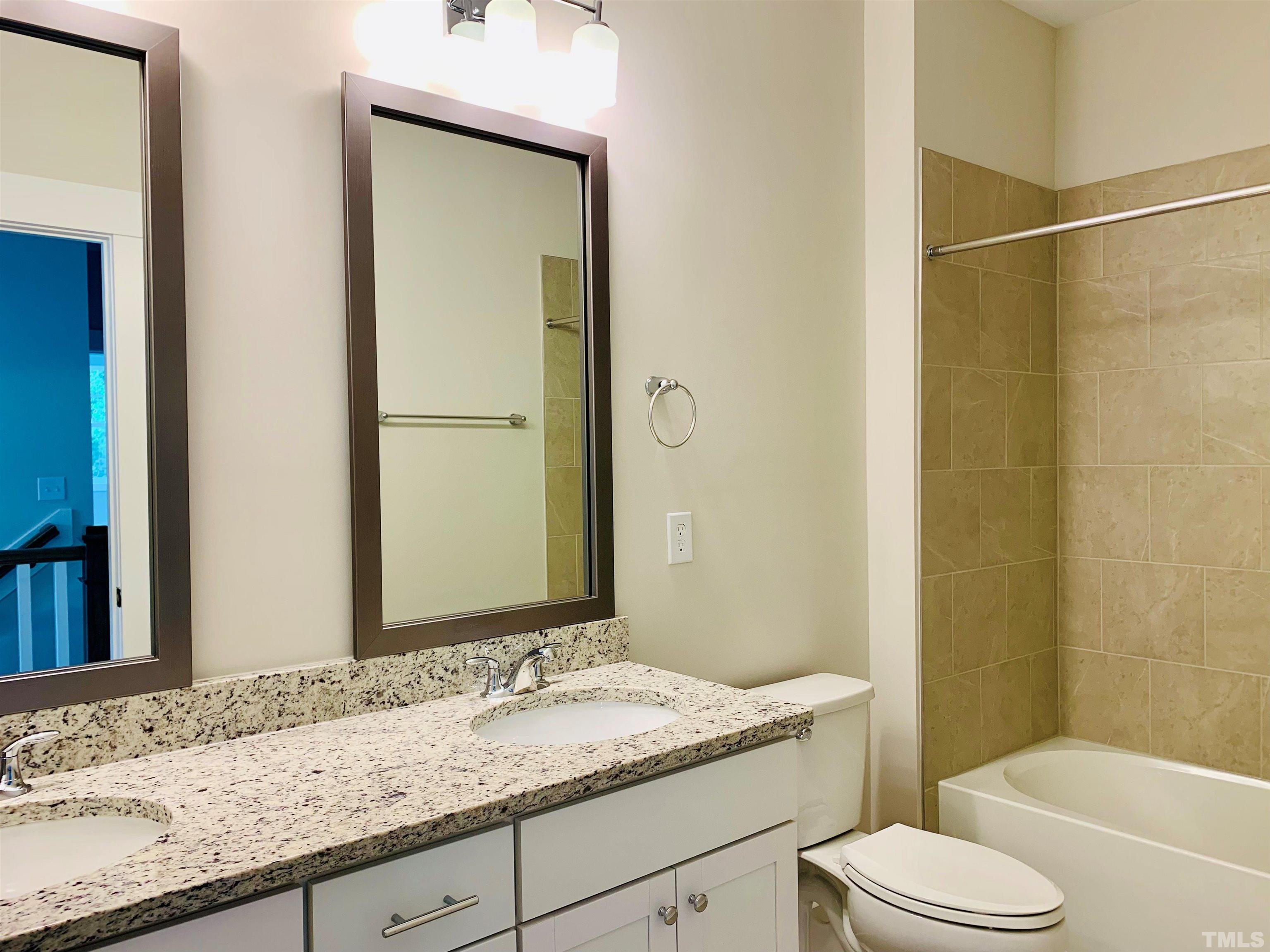 163 DUNLOE Loop Raleigh, NC 27603 - Photo 15 of 32 a bathroom with a granite countertop sink toilet mirror and shower