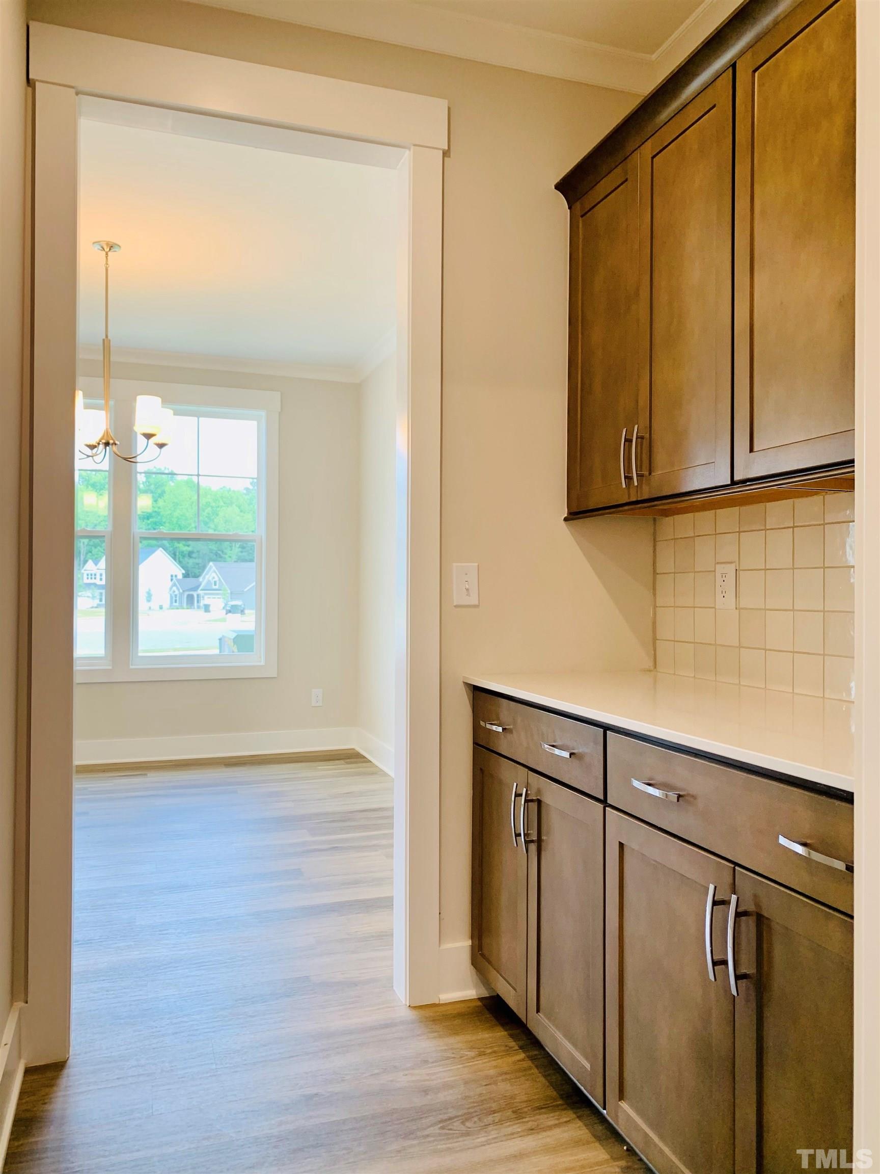 163 DUNLOE Loop Raleigh, NC 27603 - Photo 17 of 32 a view of kitchen with wooden floor and cabinets