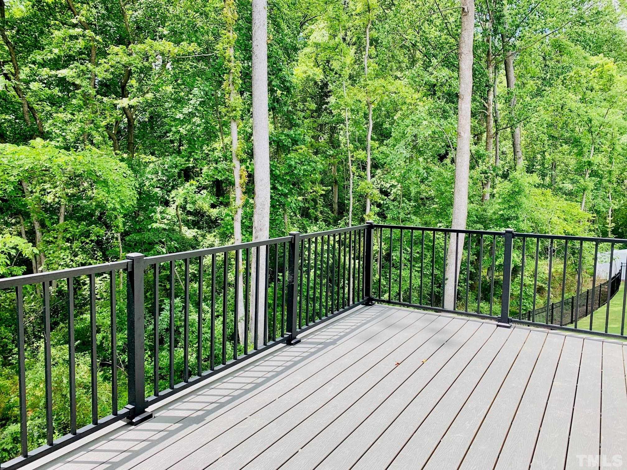 163 DUNLOE Loop Raleigh, NC 27603 - Photo 22 of 32 a balcony with trees in front of it