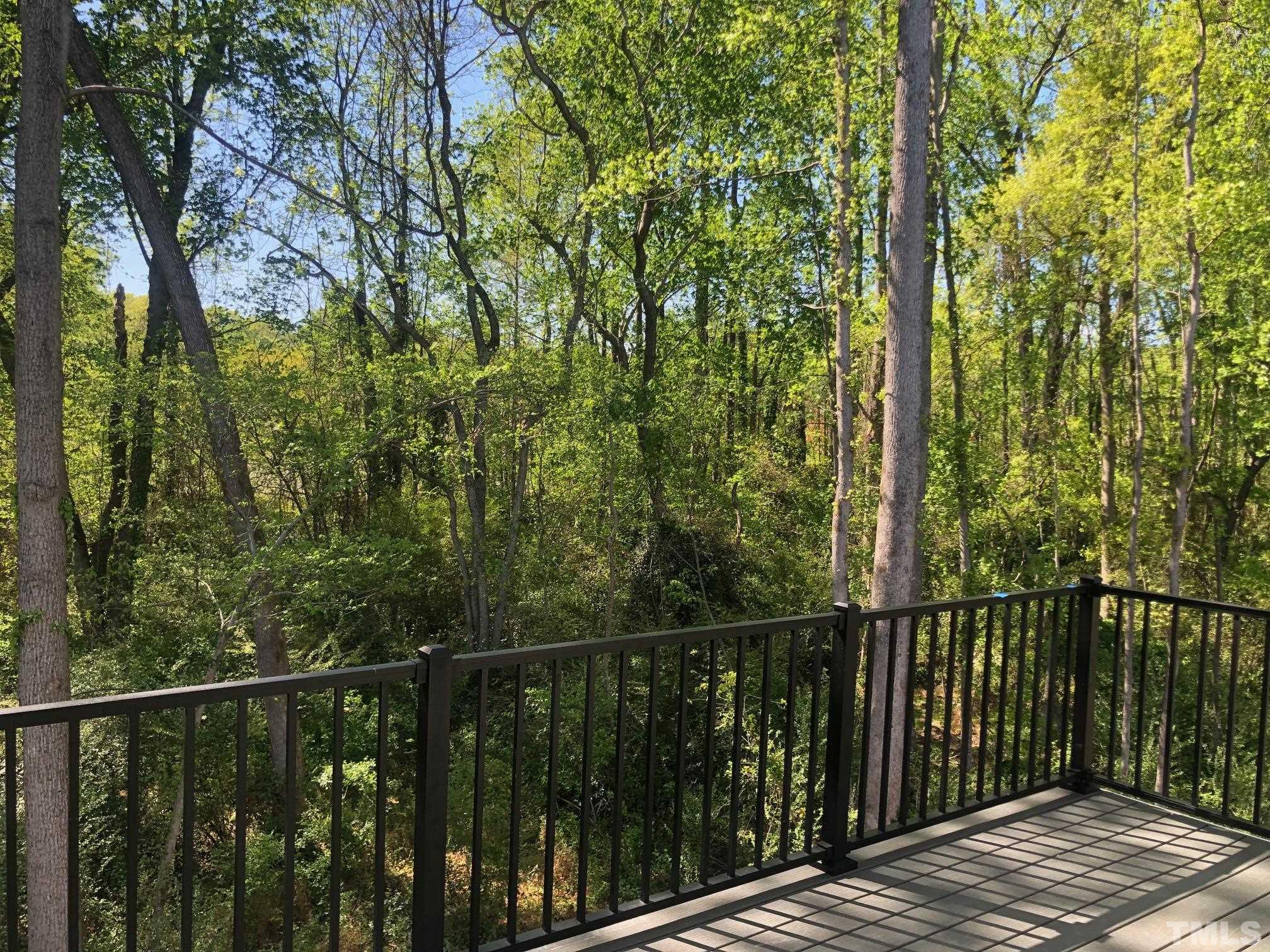 163 DUNLOE Loop Raleigh, NC 27603 - Photo 23 of 32 a view of a wooden roof deck