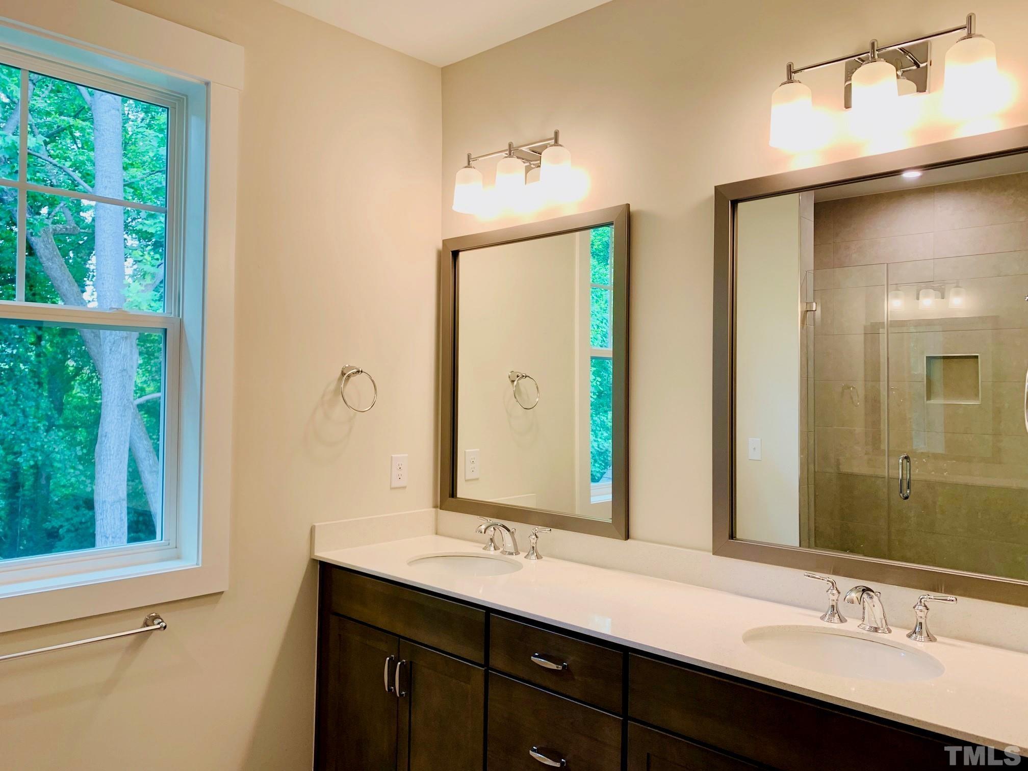163 DUNLOE Loop Raleigh, NC 27603 - Photo 29 of 32 a bathroom with a double vanity sink and a mirror