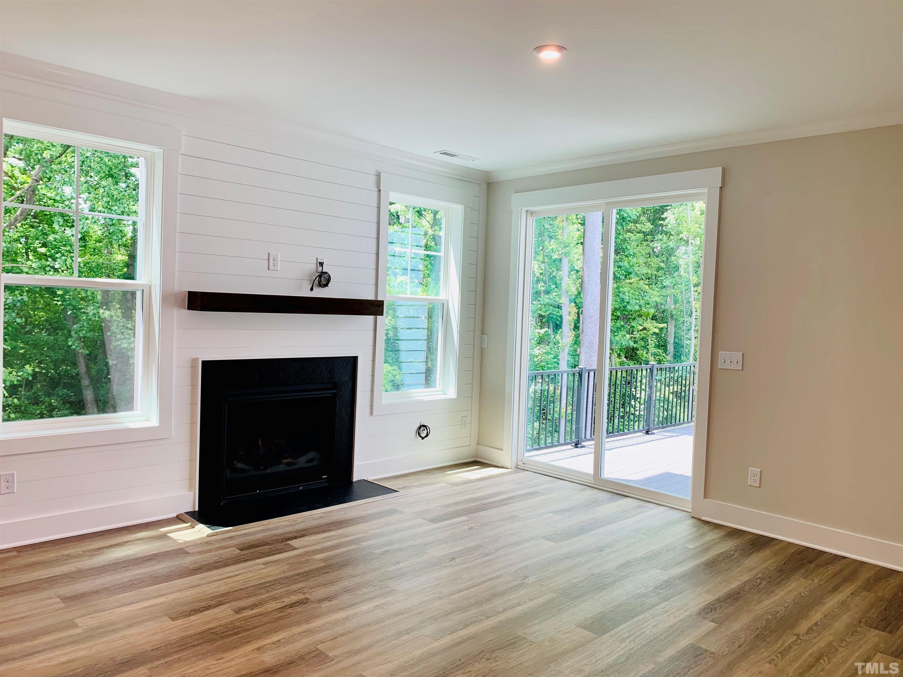 163 DUNLOE Loop Raleigh, NC 27603 - Photo 3 of 32 a view of an empty room with wooden floor and a window