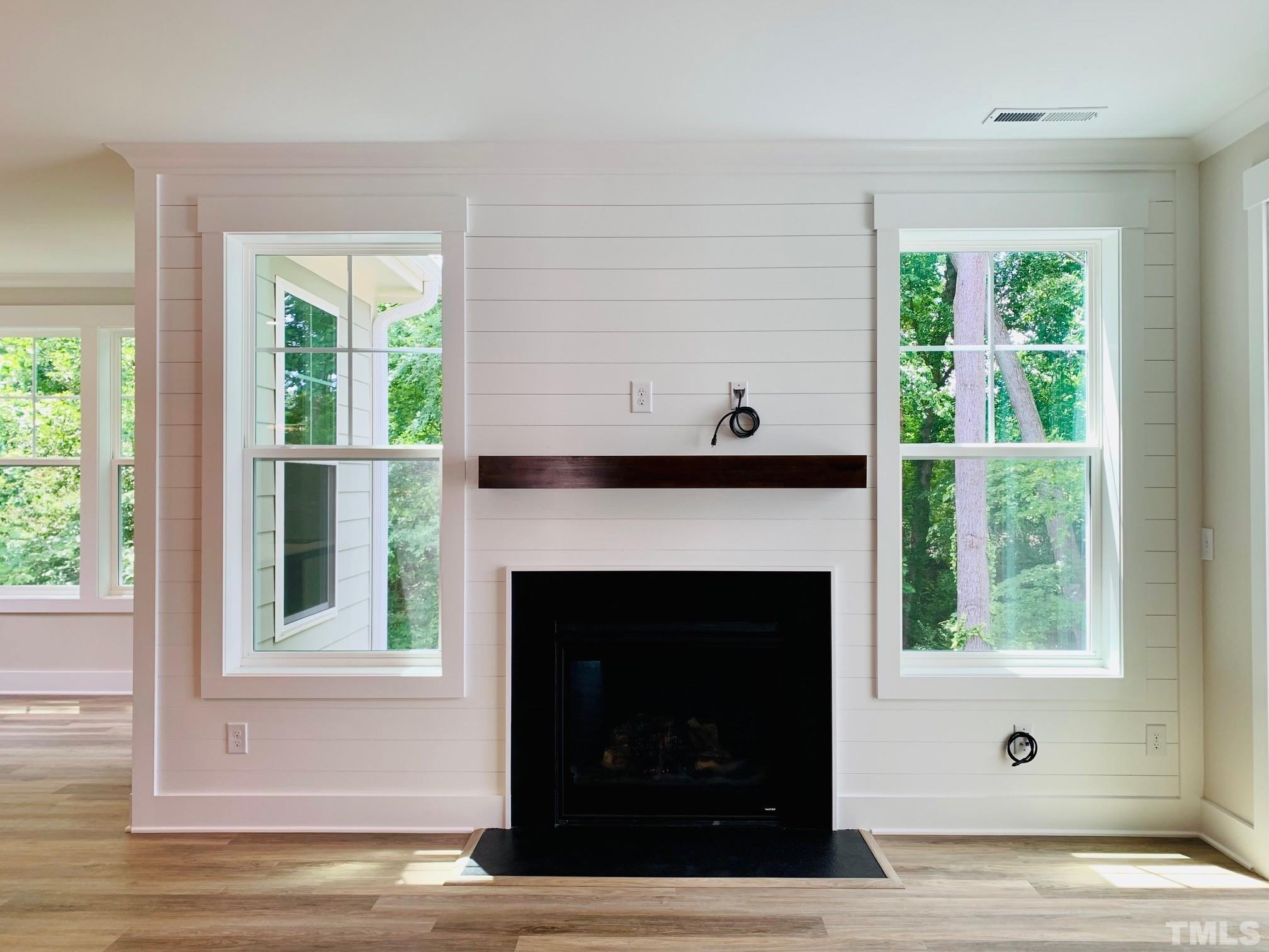 163 DUNLOE Loop Raleigh, NC 27603 - Photo 4 of 32 a living room with a fireplace and a window