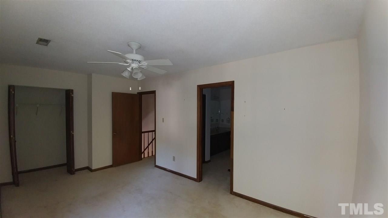 5742 Pool Side Drive Raleigh, NC 27612 - Photo 12 of 13 an empty room with closet and a ceiling fan