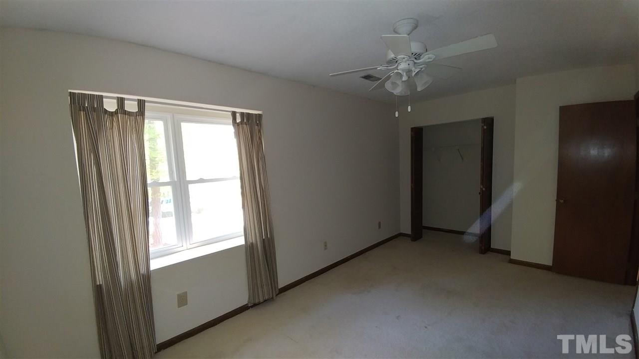 5742 Pool Side Drive Raleigh, NC 27612 - Photo 13 of 13 a view of an empty room with a window