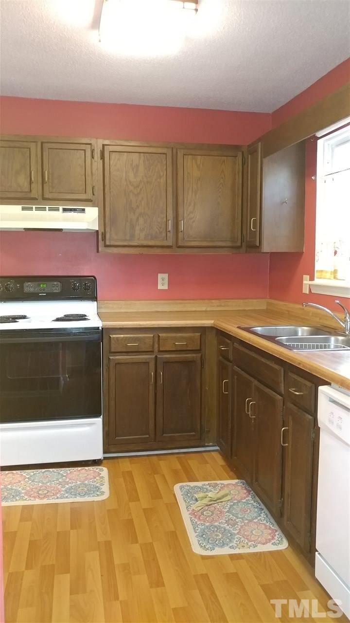 5742 Pool Side Drive Raleigh, NC 27612 - Photo 6 of 13 a kitchen with a stove and a sink
