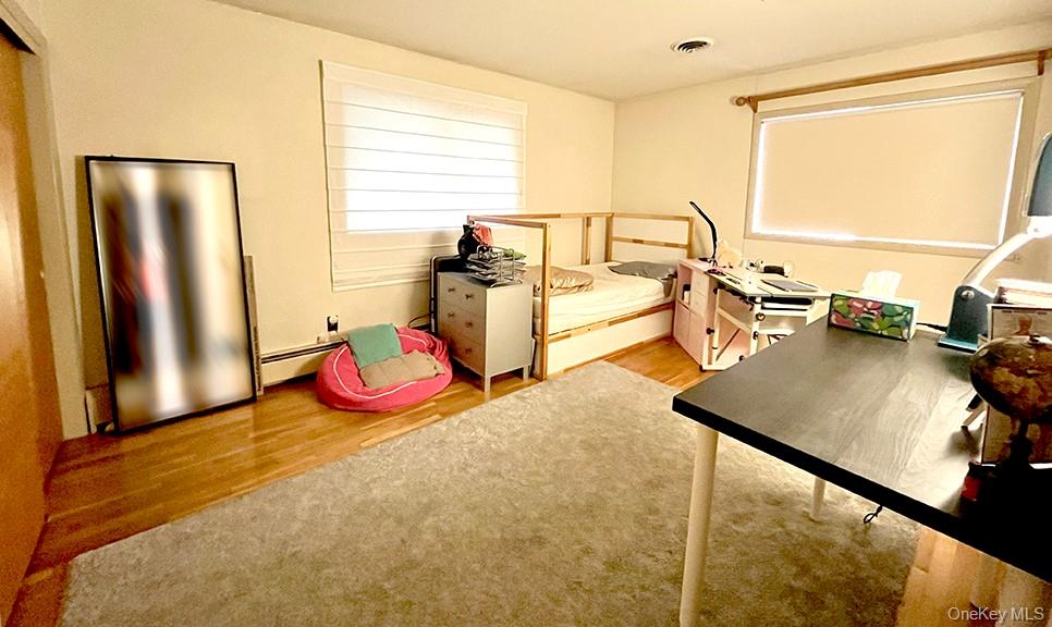 457 Quaker Ridge Road New Rochelle, NY 10804 - Photo 14 of 21 a bedroom with a bed and wooden floor