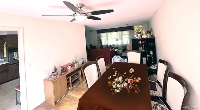 a view of a dining room with furniture and chandelier