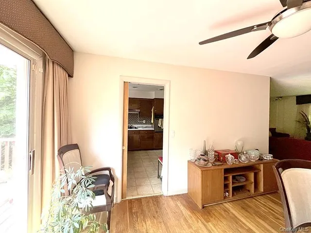 a view of a workspace with furniture and a window
