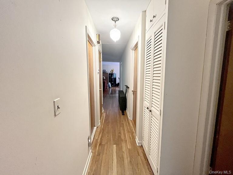 457 Quaker Ridge Road New Rochelle, NY 10804 - Photo 10 of 21 a view of a hallway with wooden floor and staircase