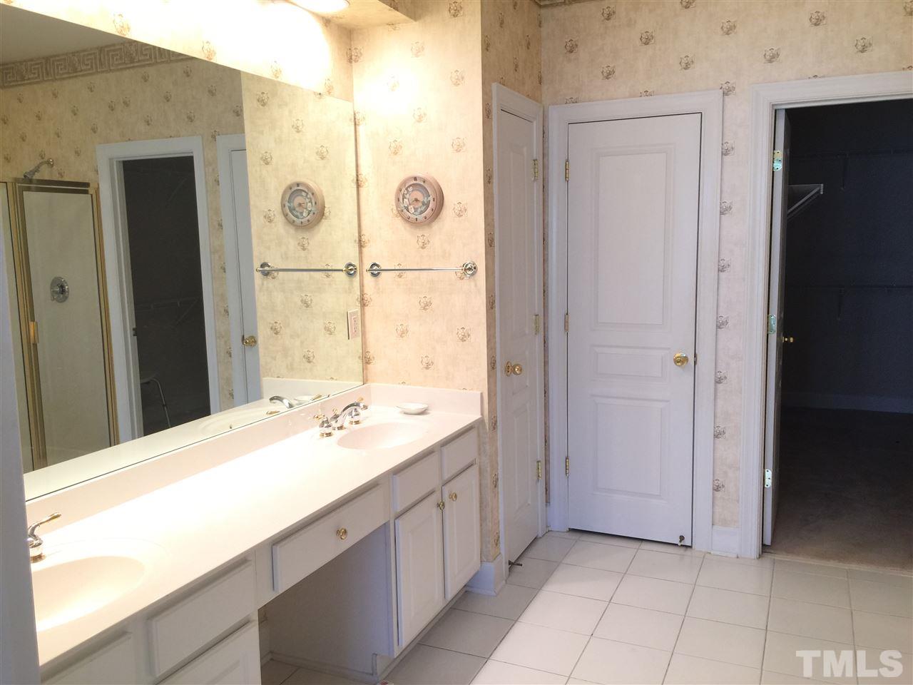 3900 Sunset Maple Court Raleigh, NC 27612 - Photo 11 of 20 Double vanity, tile floor, linen closet, water closet.