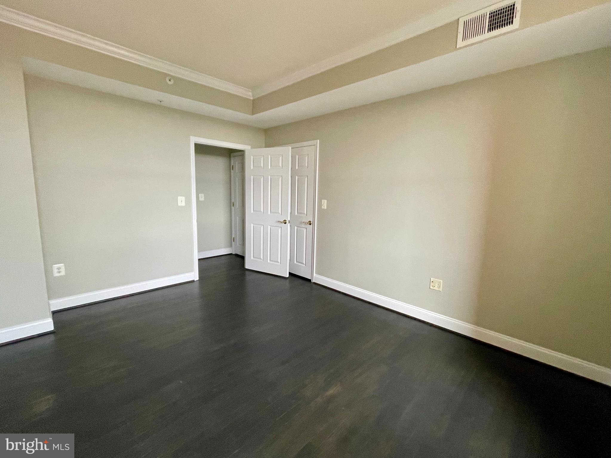 11776 Stratford House Place, Unit 1205 Reston, VA 20190 - Photo 11 of 16 a view of an empty room with wooden floor and a window