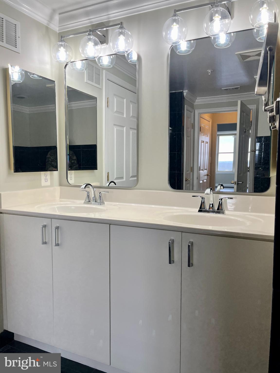 11776 Stratford House Place, Unit 1205 Reston, VA 20190 - Photo 12 of 16 a bathroom with a sink and a mirror