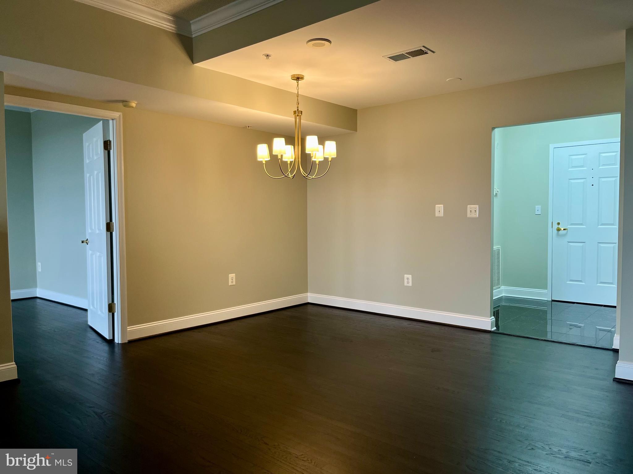 11776 Stratford House Place, Unit 1205 Reston, VA 20190 - Photo 14 of 16 an empty room with wooden floor and windows