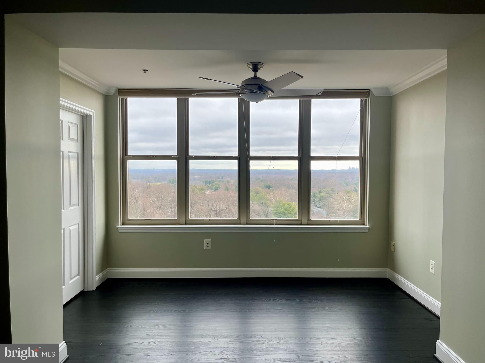 11776 Stratford House Place, Unit 1205 Reston, VA 20190 - Photo 7 of 16 an empty room with wooden floor and a window