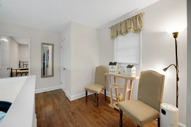 a view of a workspace with furniture and wooden floor