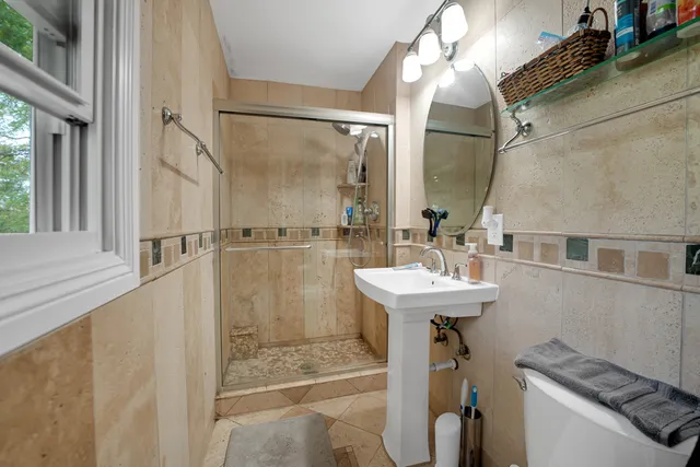 a bathroom with a sink a mirror and a shower