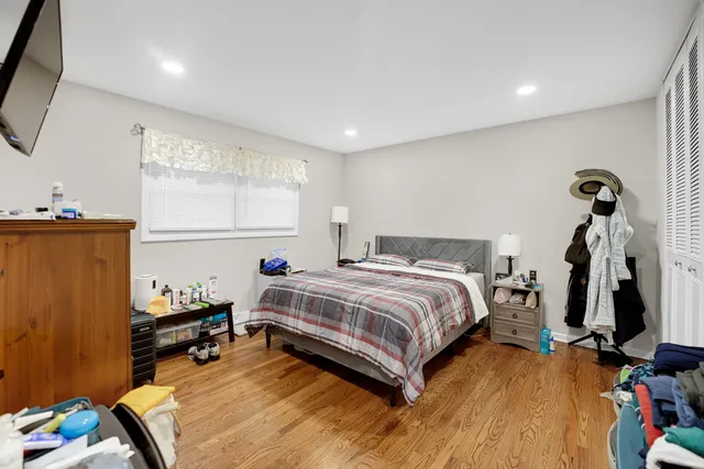 a bed room with a bed and a flat tv screen