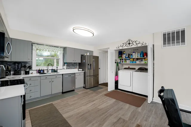 a kitchen with refrigerator and cabinets