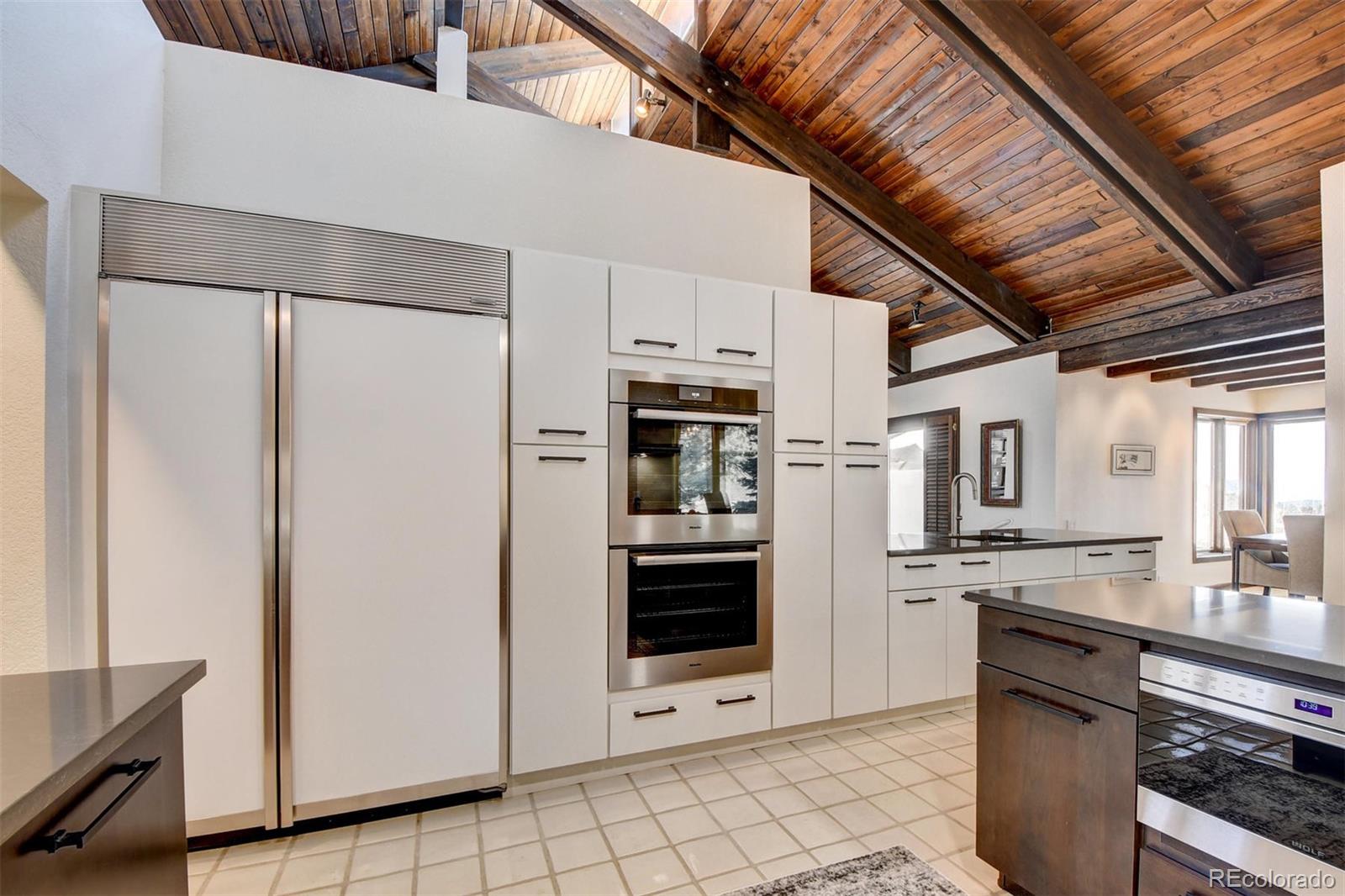 574 Spring Ranch Drive Golden, CO 80401 - Photo 11 of 40 a kitchen with stainless steel appliances a refrigerator and a stove