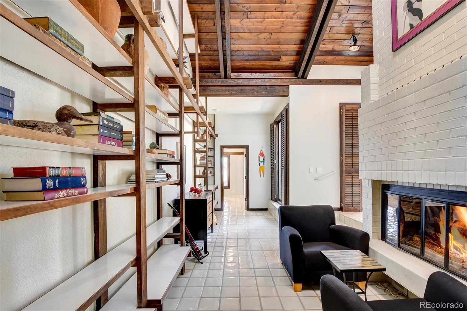 574 Spring Ranch Drive Golden, CO 80401 - Photo 16 of 40 a living room with furniture a fireplace and a dining table